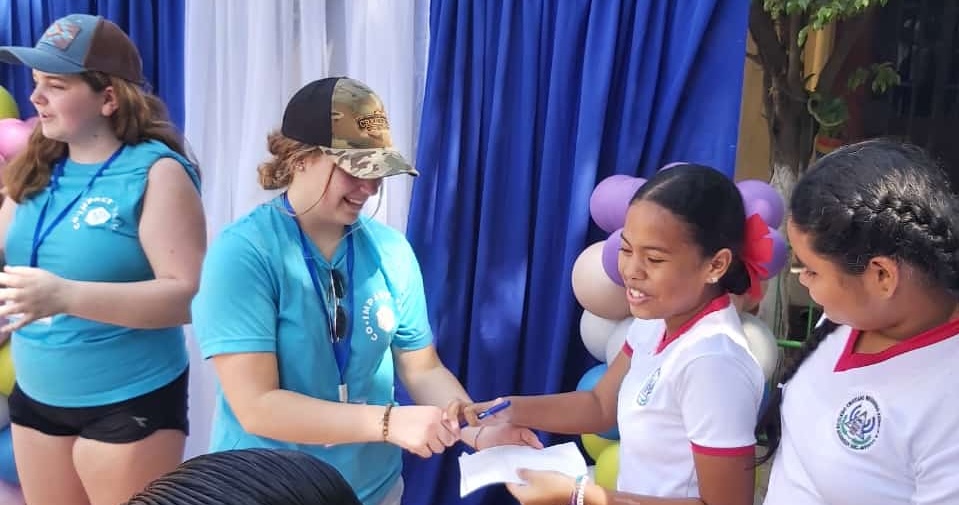 Canadian and Nicaraguan students smile at each other.