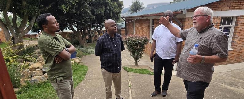 Four men discussion vision for Christian Schools Rwanda.