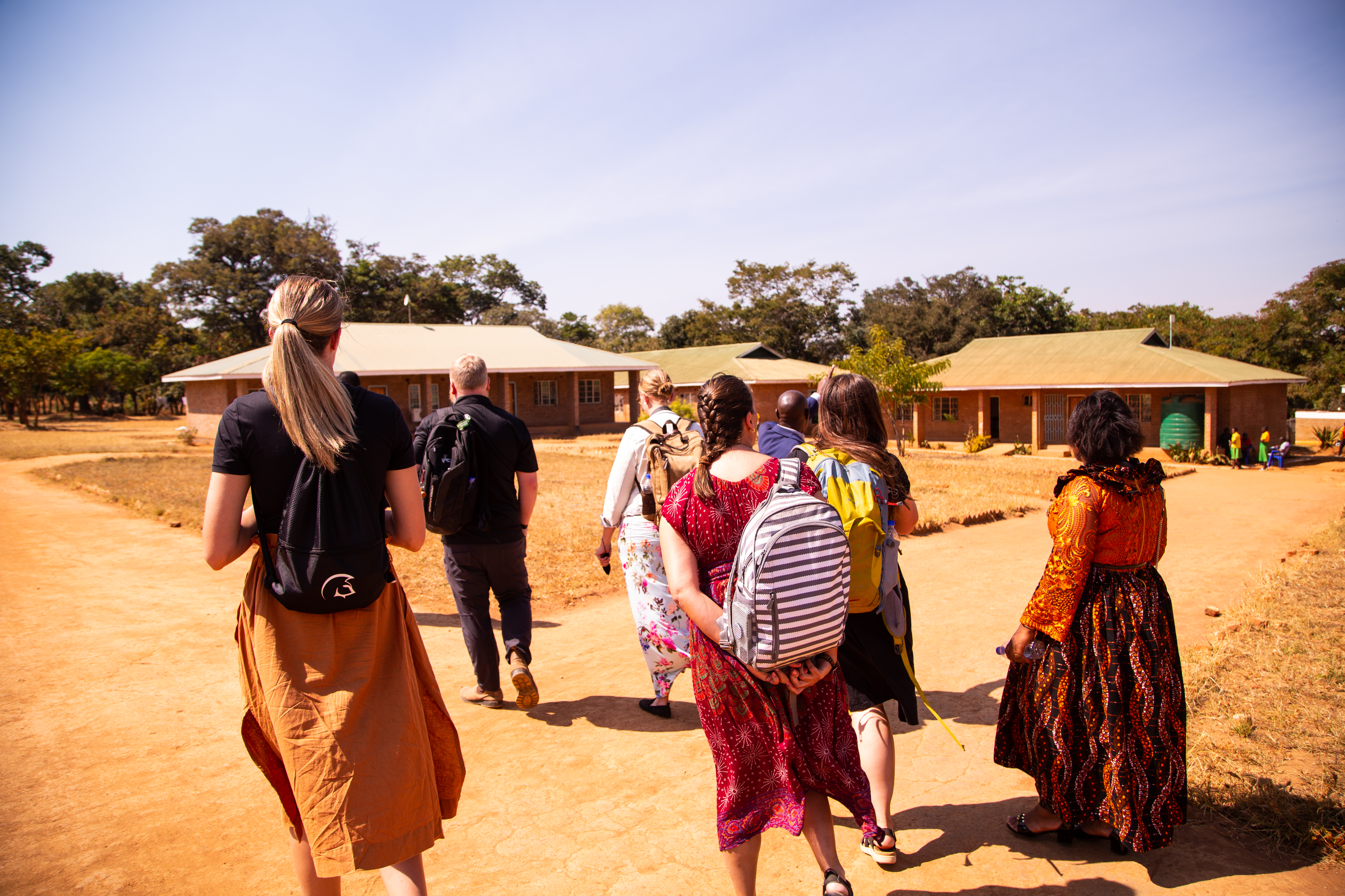 Educators walking around a school in Malawi