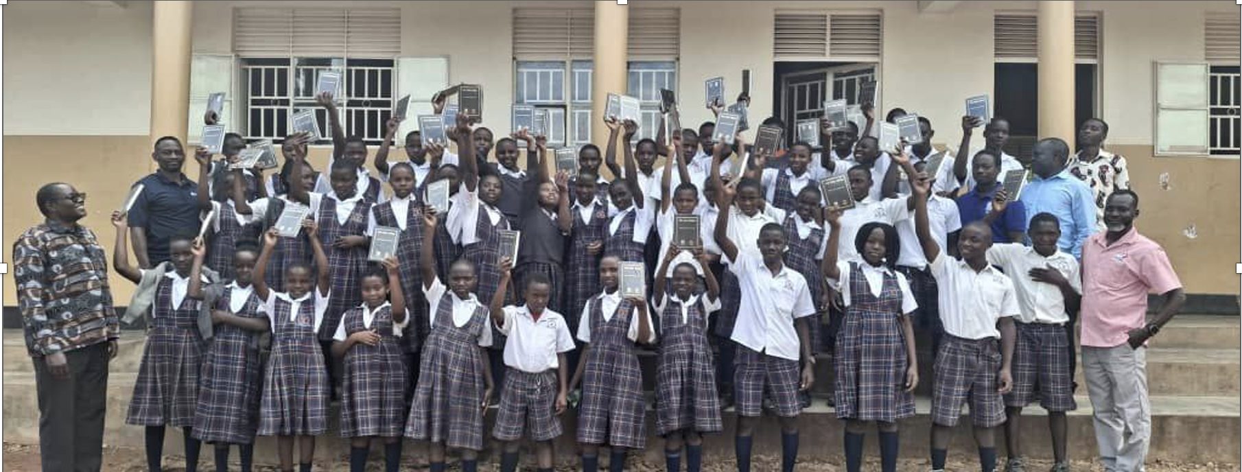 Students in Uganda holding up their new bibles.